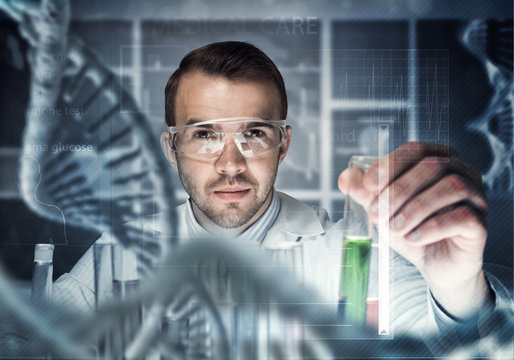 Portrait of concentrated male scientist working with reagents in laboratory