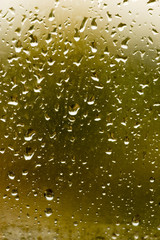 drops of rain on the window as a background