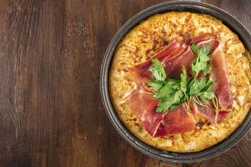 Overhead closeup photo of Spanish tortilla with copy space