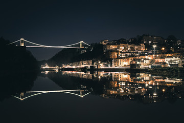Bristol's Clifton Suspension Bridge reflecting in the river Avon at night.
