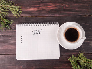 New Year background with notebook, cup of coffee