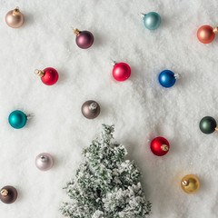 Minimal Christmas tree decoration in snow. New Year holiday party concept. Flat lay.