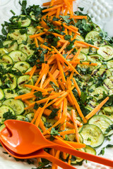 Gemüseplatte mit Zucchini und Möhren und frischen Kräutern