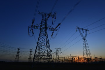 The silhouette of the evening electricity transmission pylon