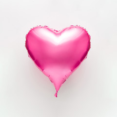 Pink heart balloon on bright background. Minimal love concept.