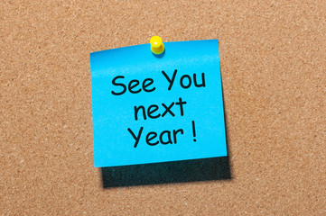 phrase See you next year pinned at cork board