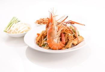Thai cruisine - Pad Thai, stir-fried rice noodle dish with shrimp, egg and side dishes