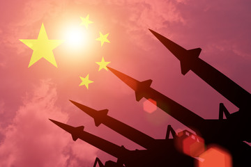 Antiaircraft rockets silhouettes on background of China flag. Sunny. - obrazy, fototapety, plakaty