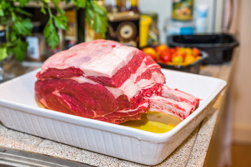 Raw beef Rib steak with bone in roasting tray on wooden table