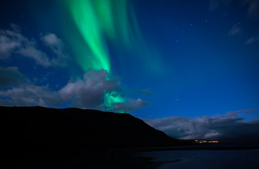Northern lights background dancing over lake in Abisko national park in Sweden