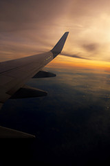 Beautiful view from window of airplane in sunrise sky
