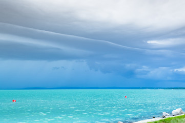 Fototapeta na wymiar Dramatic before storm view at a turquoise lake