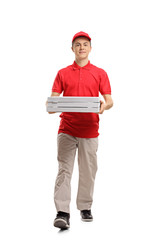 Teenage pizza delivery boy walking towards the camera