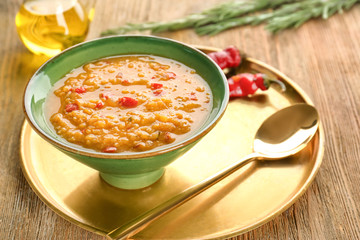 Bowl with tasty lentil soup on metal tray