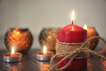Burning candles on table