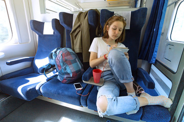 Teen girl rides a train