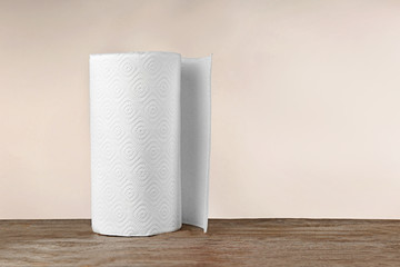 Roll of paper towels on table against light background