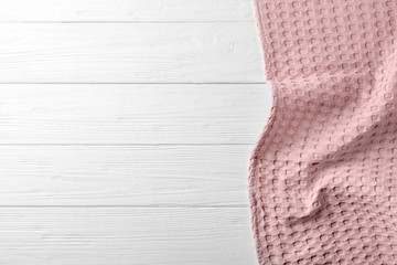 Clean kitchen towel on white wooden table