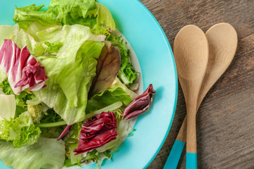 Plate of fresh salad on table, closeup