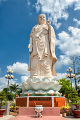 Huge Buddha statue in the garden of the famous Vinh Trang Pagoda at My Tho City, Vietnam