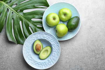 Plates with fruits on grey background