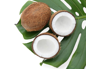 Ripe coconuts with leaf on white background