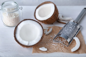 Fresh and desiccated coconut on white table
