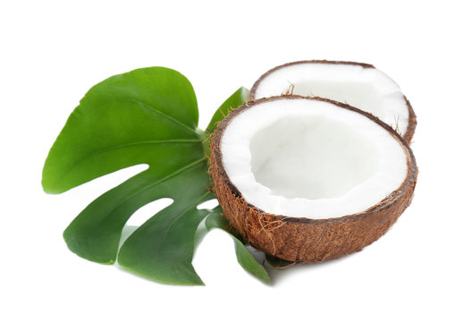 Halves of coconut with leaf on white background