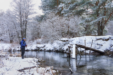 Fisherman on winter, the snow-covered river.