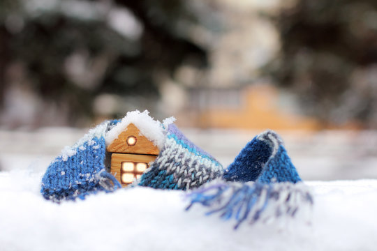 home atmosphere warming cold winters/ wooden house in the winter scarf