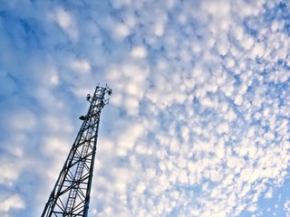 Obraz premium Telecommunication Tower in Blue Cloudy Sky