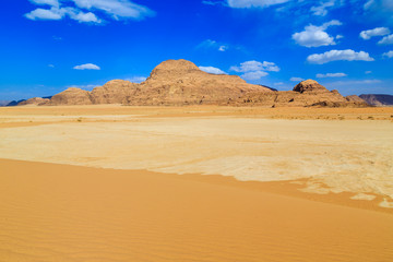 Landscape of the yellow colored mountain rocks in the Wadi rum desert in Jordan at early-morning