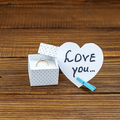 Background with the inscription I love you and the ring. Marriage proposal. The concept of...