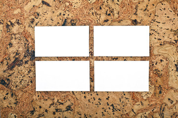 Mockup of white business cards at a cork background