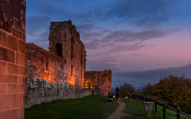 Beautiful sunset on ancient Stafford Castle with colorful sky and light on castle.
