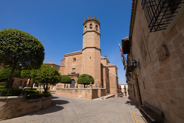 Fototapeta na wymiar landmark street and bell tower of church of San Mateo or St Matthew, gothic and renaissance from Fifteenth century, in old town of Banos de la Encina, Jaen, Andalusia, Spain Europe 