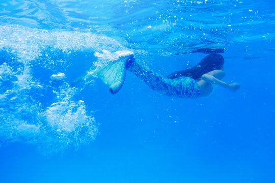 Tween Girl In Mermaid Tail Swimming In Pool 