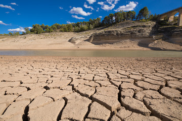 landscape of dry earth ground and low level water, extreme drought in Entrepenas reservoir, in Guadalajara, Castilla, Spain Europe
 - obrazy, fototapety, plakaty