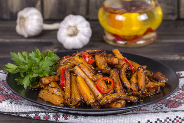 Healthy homemade roasted carrots ready to eat in black plate