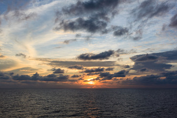 Blue sea and sky with sun red light reflected to the sea