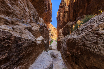 A small passage between the steep rocks at Little Petra in Siq al-Barid, Wadi Musa, Jordan