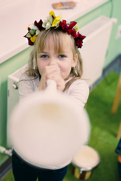 Little girl is playing on the pipe