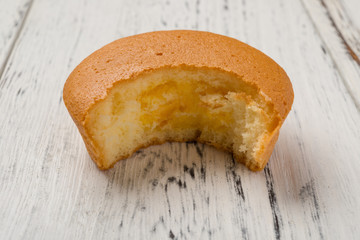 studio shoot of yolk filled pie with a bited on wood background