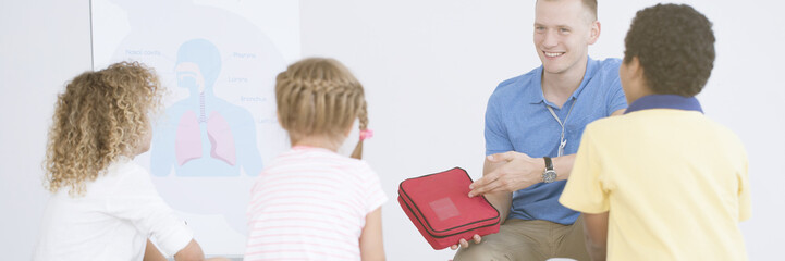 Rescuer showing first aid kit