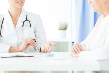 Doctor with stethoscope during consultation