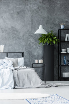 Grey lamp in monochromatic bedroom