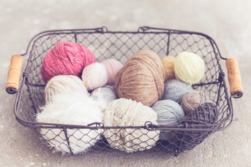 Fototapeta na wymiar coil wool, yarn, metal basket, concrete background