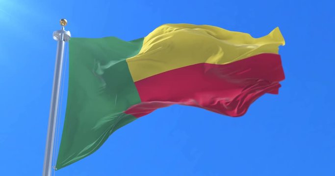 Benin flag waving at wind in slow with blue sky, loop