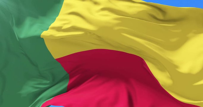 Beninese flag waving at wind in slow with blue sky, loop