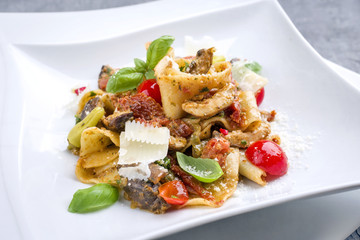 Traditional Italian pappardelle alla cozze with mushrooms and parmesan as close-up on a plate